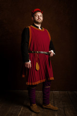 man (actor) in a 15th century costume (medieval) on an aged stylized background. Hobby,...