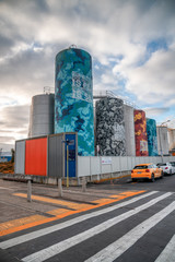 Fototapeta na wymiar AUCKLAND, NEW ZEALAND - AUGUST 26th, 2018: Colourful silos on the waterfront. Auckland attracts 5 million people annually