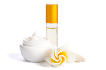 Beautiful flowers and bottles with natural skincare cream isolated on white background