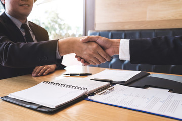 Successful job interview with boss and employee shaking hands after negotiation or interview, career and placement concept