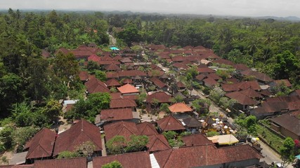 4K aerial view of traditional balinese houses. Flying over balinese village. Bali island.