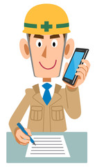 携帯電話で会話しながらメモを書く建築現場の作業員
