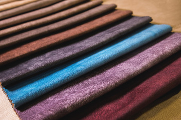 Colorful and bright fabric samples of furniture and clothing upholstery. Close-up of a palette of textile abstract stripes of different colors