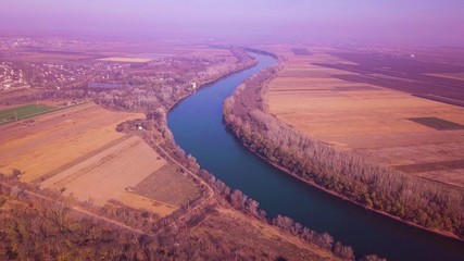 Slow drone flight over blue river