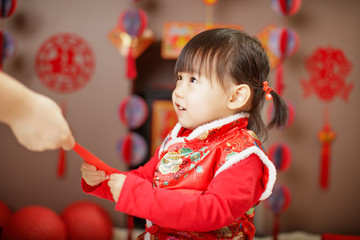 Chinese baby girl  traditional dressing up with a FU means lucky red envelope