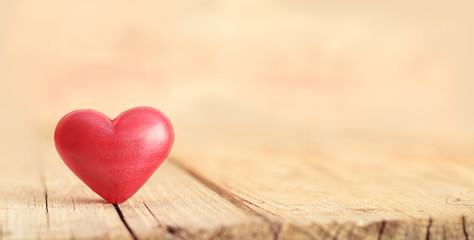 Fototapeta premium Red heart on splitted wooden desk
