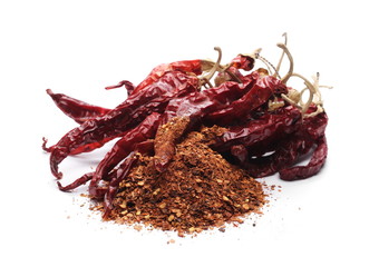 Dry spicy chili peppers and flakes, powder isolated on white background