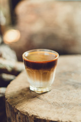 Coffee mixed with milk in a glass Morning light