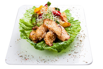 Chicken fillet with vegetables in soy-garlic sauce. On white background