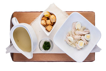 Chicken broth with quail egg. On a wooden Board. The view from the top