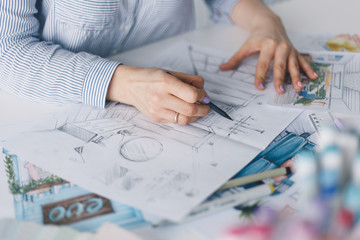 architects hands working with drawing sketch home and other working tools