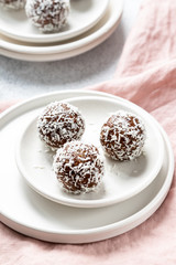 Cacao Date Energy Bites on a white blue background