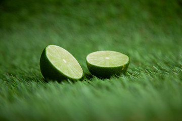 halved lime on green grass