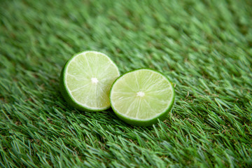halved lime on green grass
