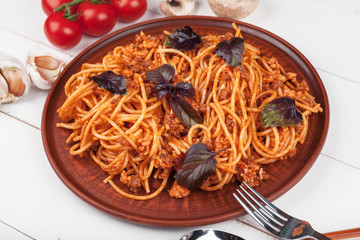 Pasta with meat, tomato sauce and vegetables on the table
