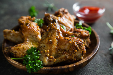 Baked chicken wings with fresh herbs and ketchup