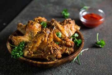 Baked chicken wings with fresh herbs and ketchup