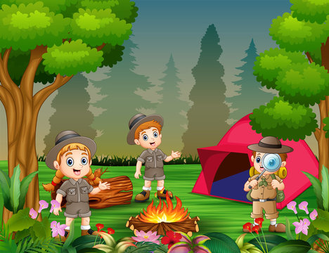 Happy children camping out in the beauful forest