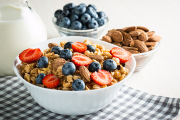 Healthy breakfast concept with oat flakes and fresh berries on rustic background. Food made of granola and muesli. Healthy banana smoothie with blackberries, honey and milk.