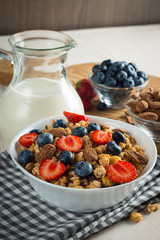 Healthy breakfast concept with oat flakes and fresh berries on rustic background. Food made of granola and muesli. Healthy banana smoothie with blackberries, honey and milk.