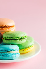 Still life and food photo of cake macarons in a gift box with flowers, a cup of tea on light background. Sweets and desserts concept of macaroons.