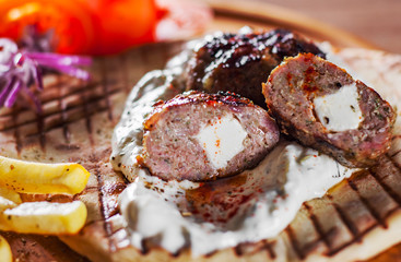 Spicy bifteki, frikadelle or frikkadel meatballs with minced beef and lamb with pita bread,...