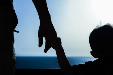 Beautiful arms of the parent and child silhouette of the background