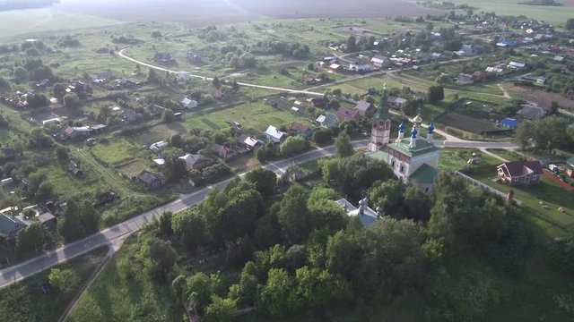 shooting the village and the church on a summer day from above with a quadrocopter