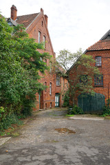 Fototapeta na wymiar old homestead or farmstead with red brick buildings 