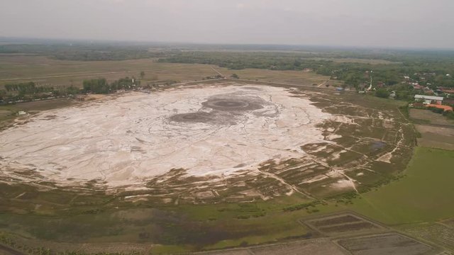Mud volcano with bursting bubble bledug kuwu. aerial view volcanic plateau with geothermal activity and geysers, Indonesia java. aerial view volcanic landscape