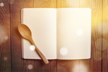 Empty notebook for recipes with spoon