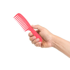 Red comb in hand isolated on white background
