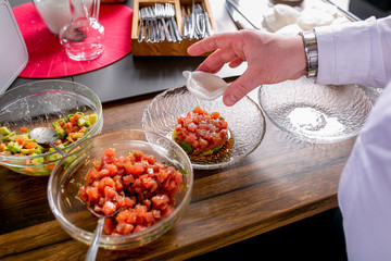 Chef puts tuna tartare on a plate. Master class in the kitchen. The process of cooking. Step by step. Tutorial. Close-up
