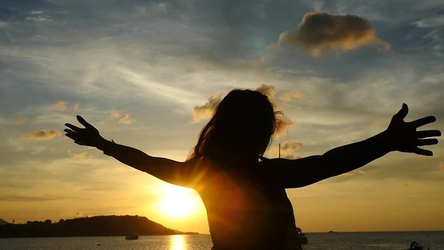Young woman outstretching arms at amazing sunset. Sea cruise in Thailand. Slow Motion. 1920x1080