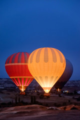 Beautiful hot air balloons flying over Cappadocia landscape at sunrise