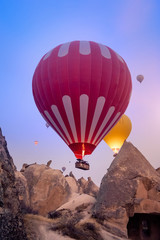 Obraz premium Beautiful hot air balloons flying over Cappadocia landscape at sunrise
