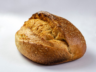 Whole grain bread on a white background. Fresh bread close up. Fresh baked white background. Healthy food and traditional bakery conce
