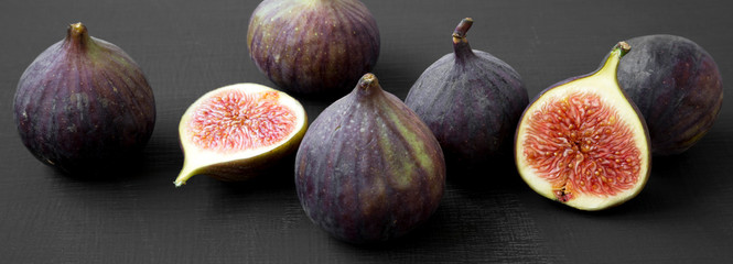 Fresh figs on dark black background, side view. Close-up.