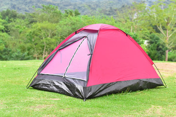 Pink color dome tent and mountain range landscapes in the background.