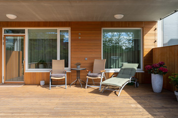 Photo of wooden house with plank board wall on terrace