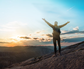 Woman successful hiking silhouette in mountains, motivation and inspiration in beautiful sunset. Female hiker with arms up outstretched on mountain top, inspirational landscape