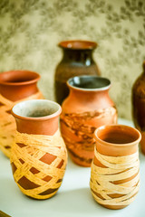 Closeup fragment ceramic vase. Folk craft Latvia. Traditionally, the products are painted with restrained, earthy shades. Selective focus. Best pottery for home.