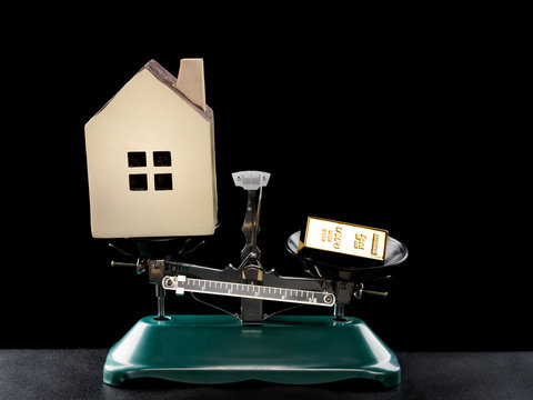 house lighter than a gold bar on black concept of house worthless