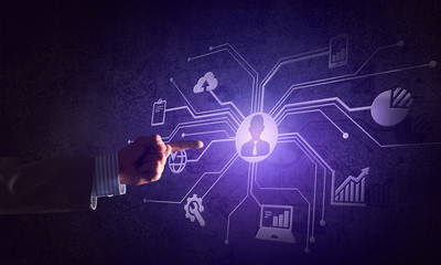 Close of businessman hand showing at user interface glowing on wall