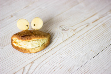 frog made is juicer  ,Homemade baking, cookies and decorations, juicer with curd  on white wooden table free space for text -holidays, celebration and children concept 