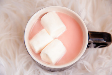 Kawaii pink sweet drink, Hot strawberry flavored milk with marshmallows on the white mouton rug.