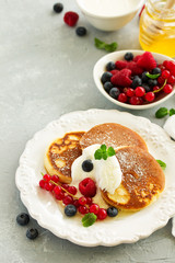 Breakfast - Cottage cheese pancakes,  curd fritters with raspberry, strawberry, blueberry.  Selective focu