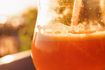 Orange Smoothie In Glass With Straw At Sunset