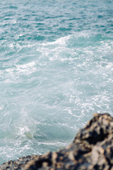 Sea in Cyprus at sunset. Beautiful spray and blue water.