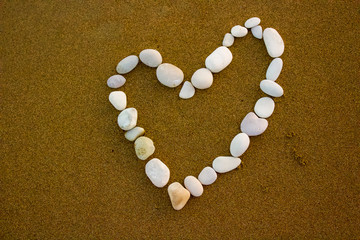 Fototapeta na wymiar Heart stones on the sandy beach